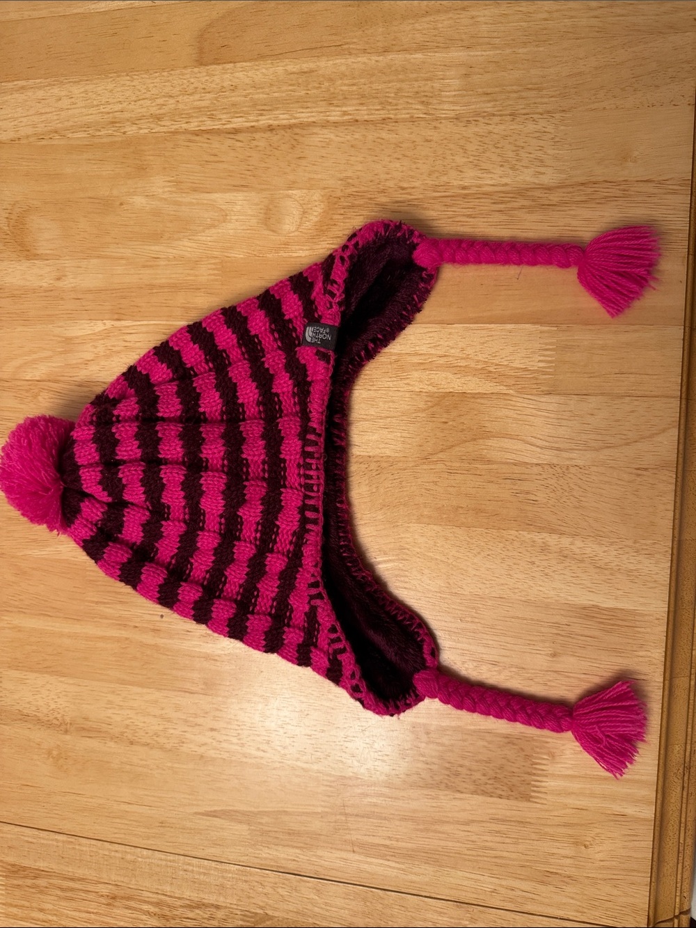 The North Face Pink and Black Striped Earflap Hat with Pom-Poms